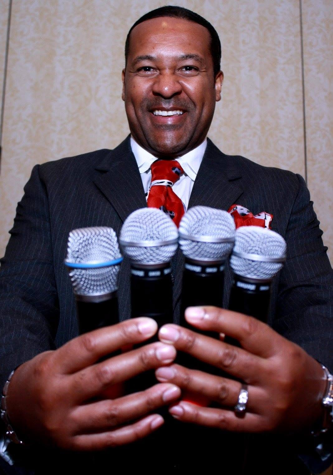 Kevin T. Robertson holding microphones for booking inquiries
