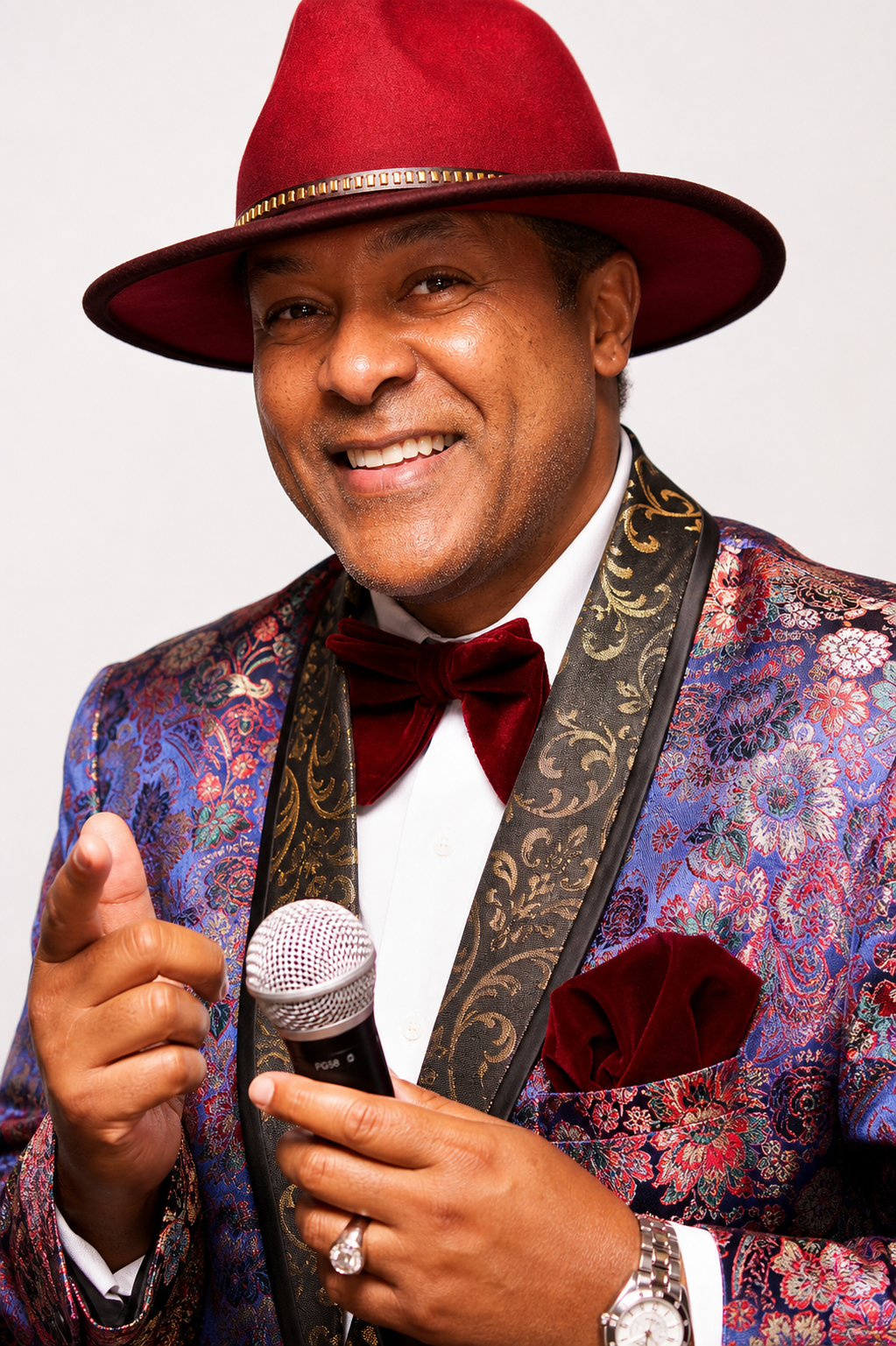 Kevin T. Robertson in red hat and patterned jacket